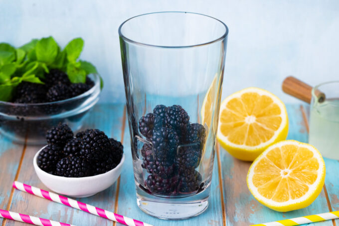 Making blackberry mojito.