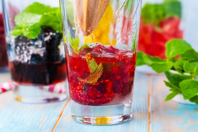 Making raspberry mojito.