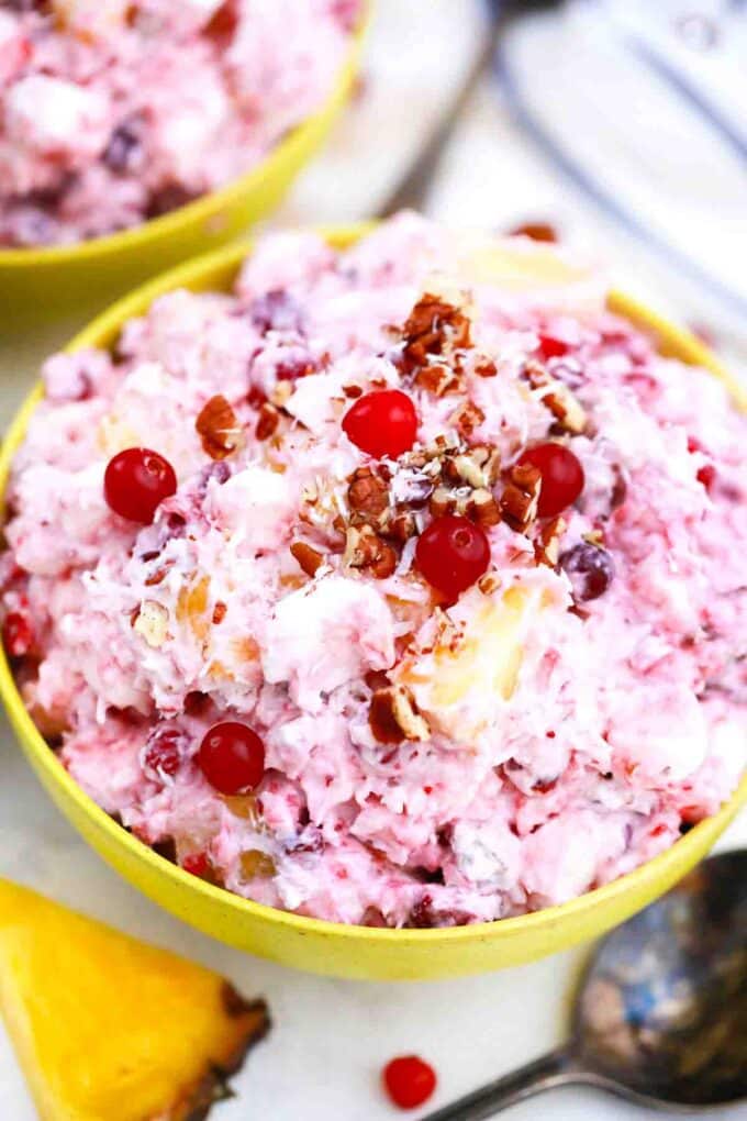 bowl with mllionaire cranberry salad topped with pecans