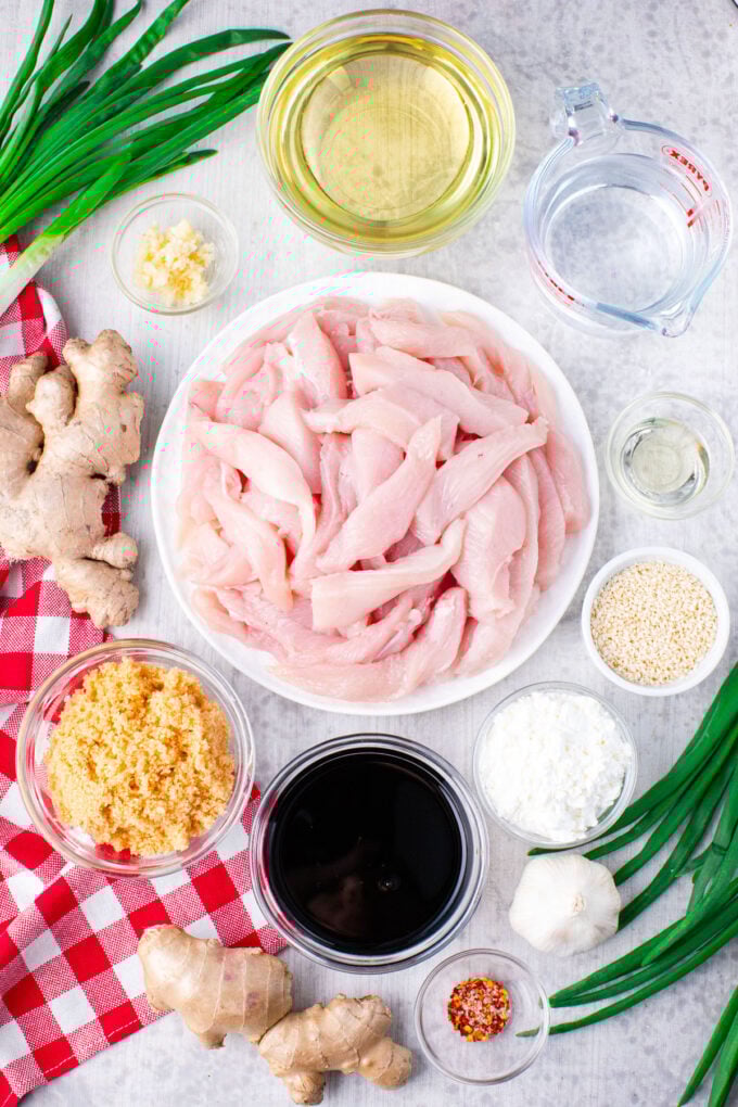 Overhead shot of Mongolian chicken ingredients in bowls on a table.