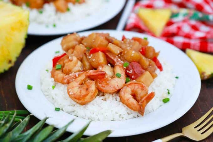 a plate of white rice with pineapple shrimp