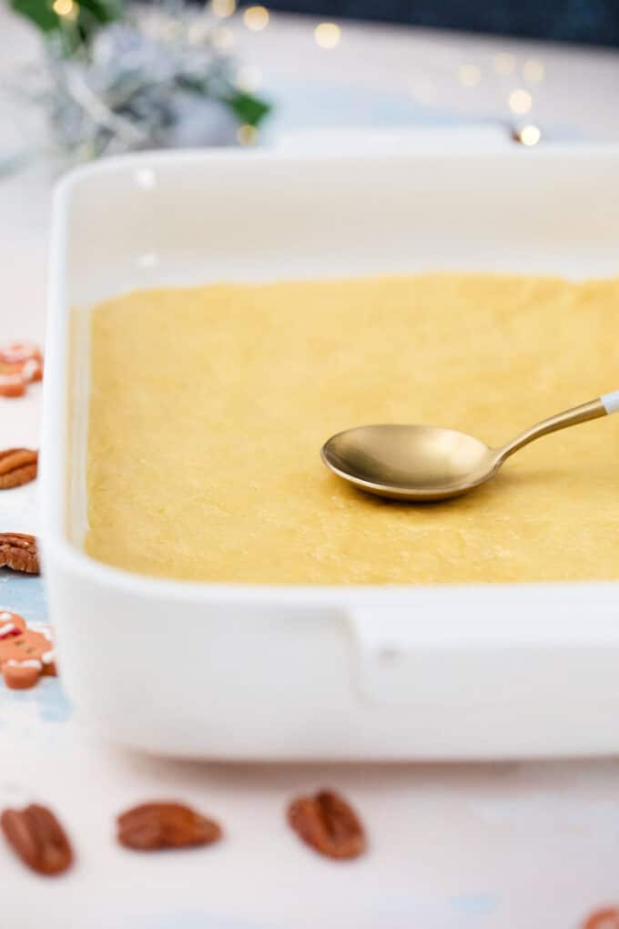 pressing a shortbread crust in a baking dish