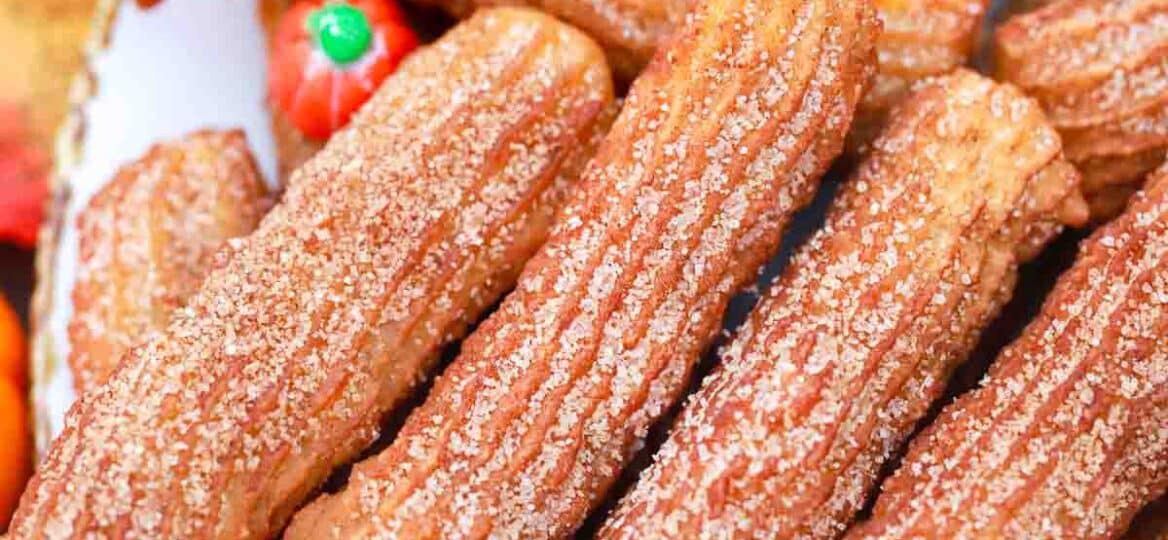 sugar covered pumpkin churros on a plate