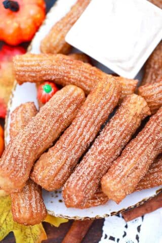 sugar covered pumpkin churros on a plate