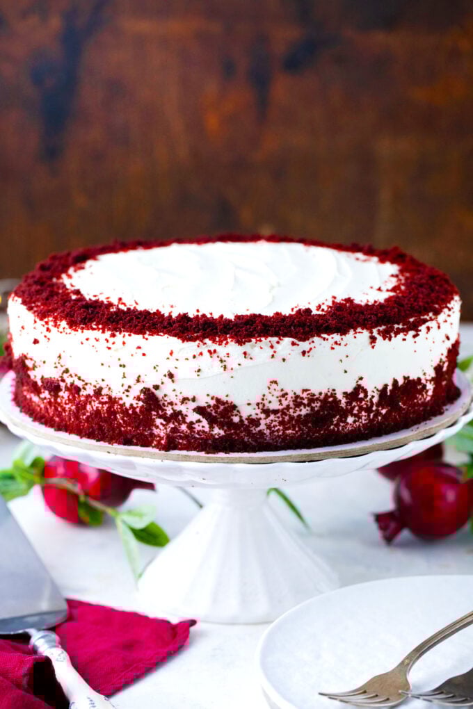 Homemade red velvet cake on a cake stand.