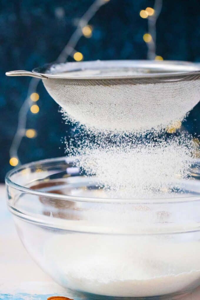 sifting flour over a bowl