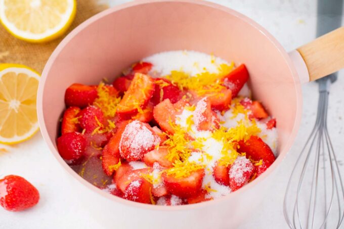 Homemade strawberry jam ingredients in a sauce pan.