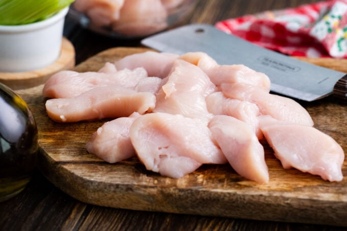 Chicken pieces on a cutting board.