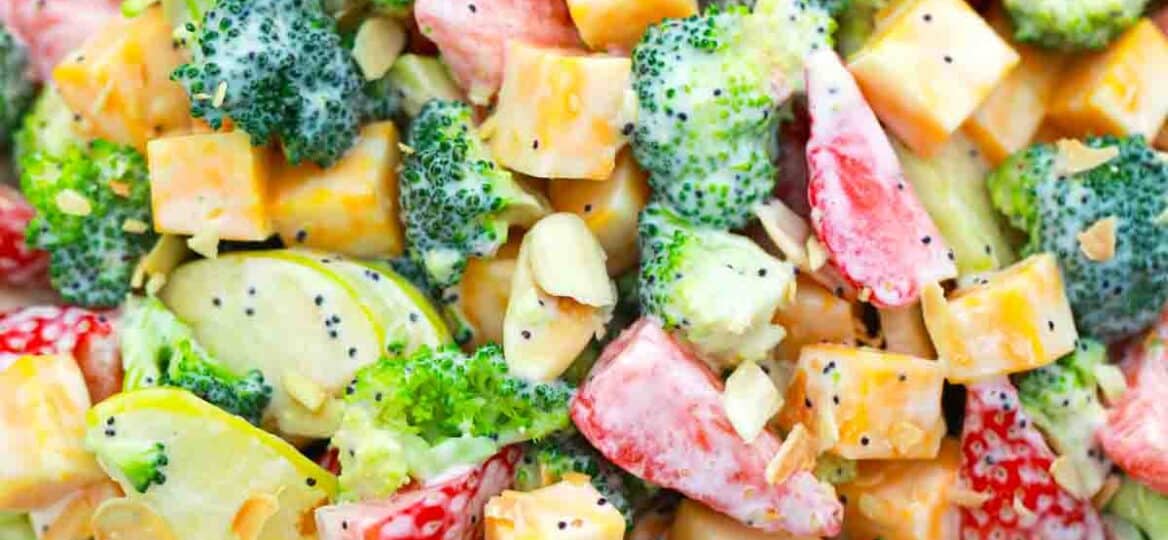 overhead close shot of strawberry broccoli salad with cheese and poppy seeds dressing