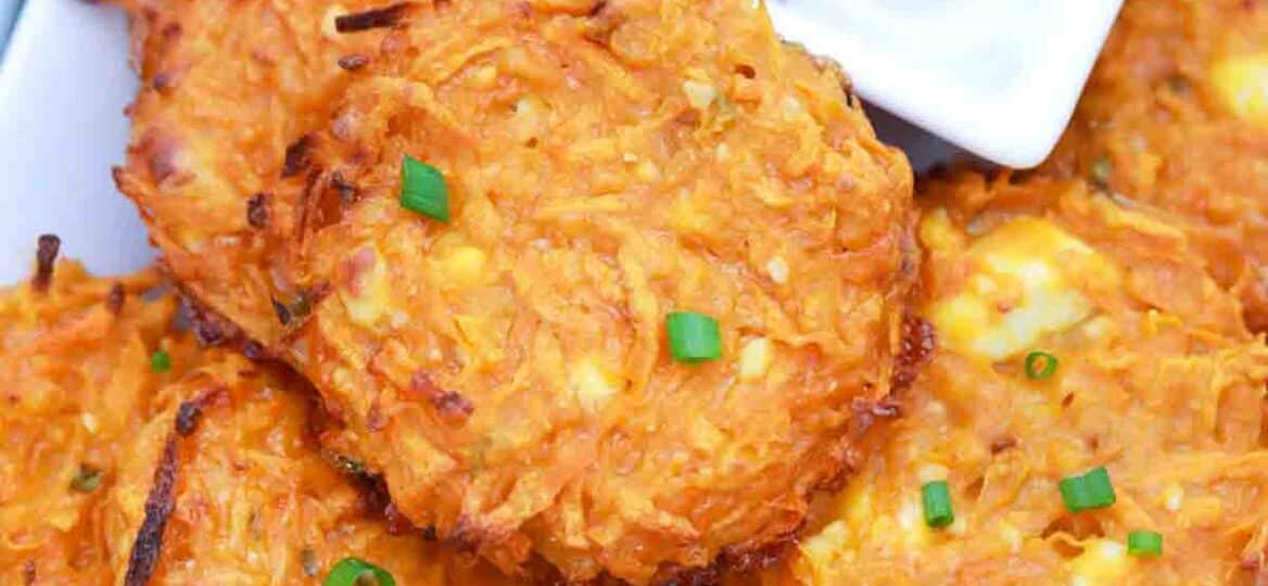 overhead shot of crispy sweet potato fritters with white sauce