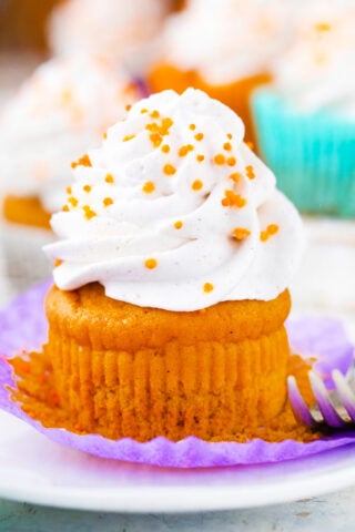 Sweet potato pie cupcake topped with whipped cream.