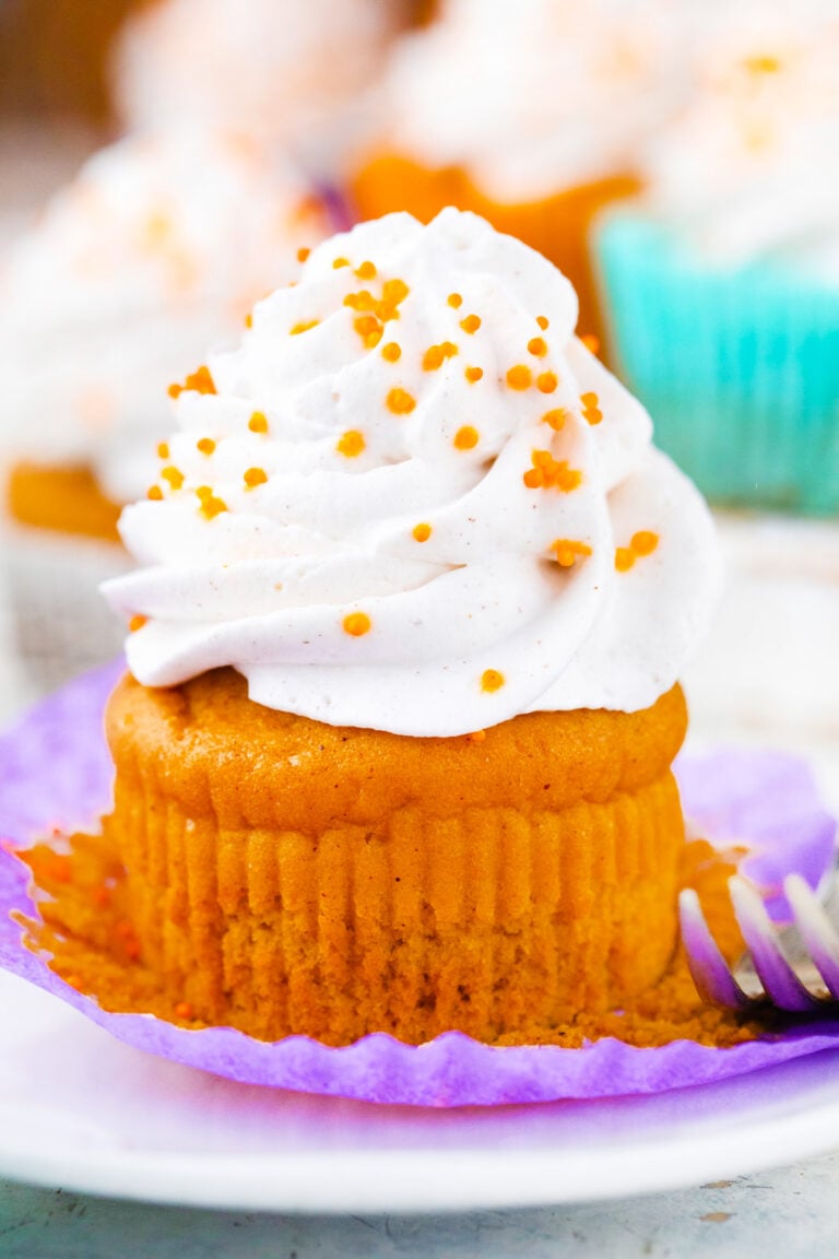 Sweet potato pie cupcake topped with whipped cream.