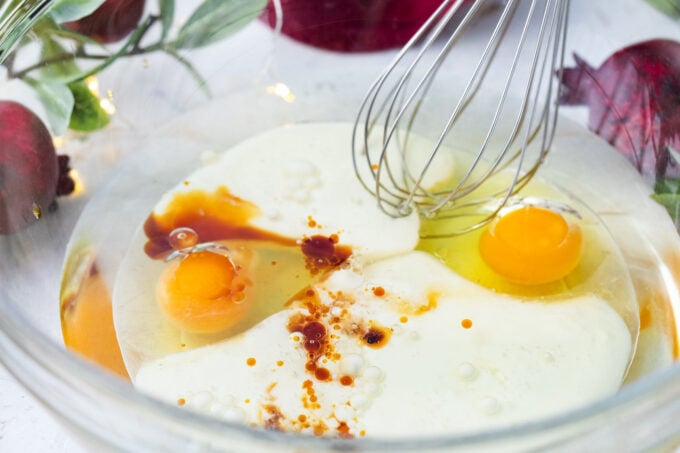 Mixing wet ingredients for red velvet cake.