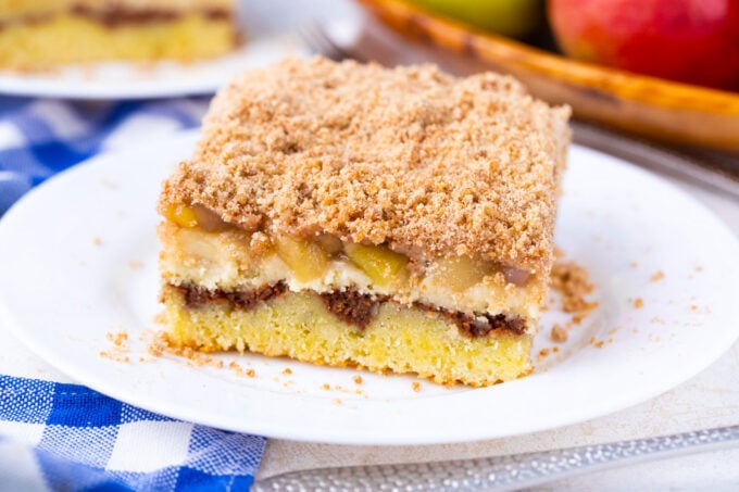 A slice of apple pie coffee cake with cinnamon filling and apple pie filling.