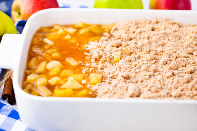 Adding streusel topping over apple pie filling layer.