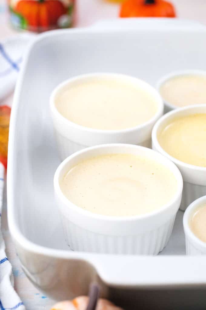 pumpkin pie creme brulee ramekins in a baking dish