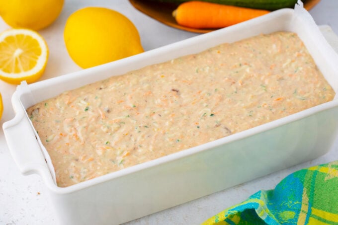 Carrot zucchini bread batter in a baking loaf pan.