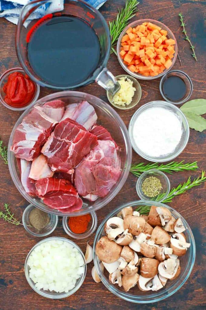 overhead shot of beef tips mushrooms wine carrots spices and herbs