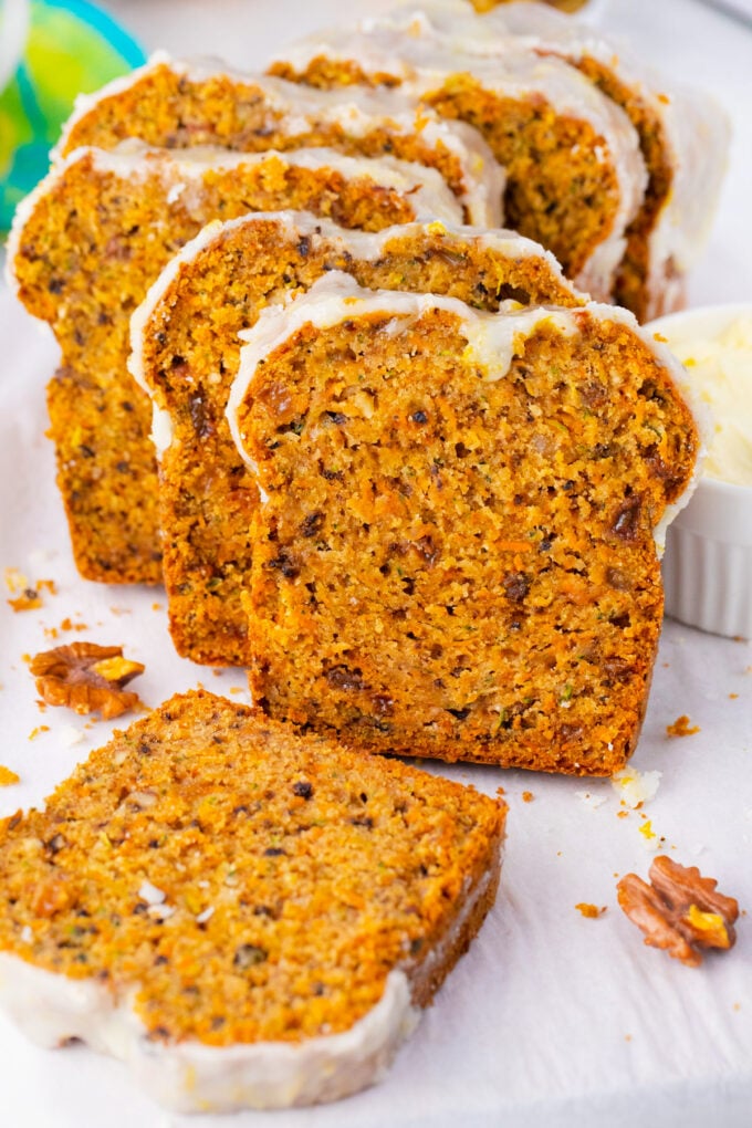 Sliced carrot zucchini bread with lemon glaze.