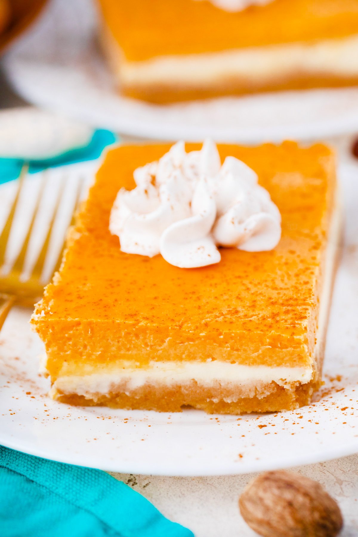 Sweet potato cheesecake bar topped with whipped cream.
