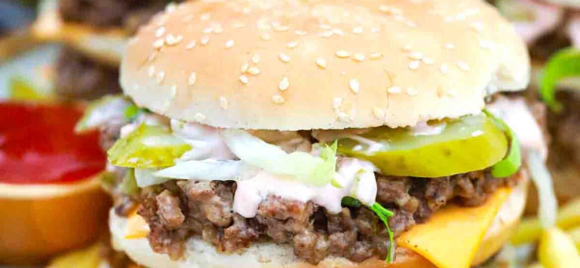 big mac sloppy joes on a plate with fried in the background