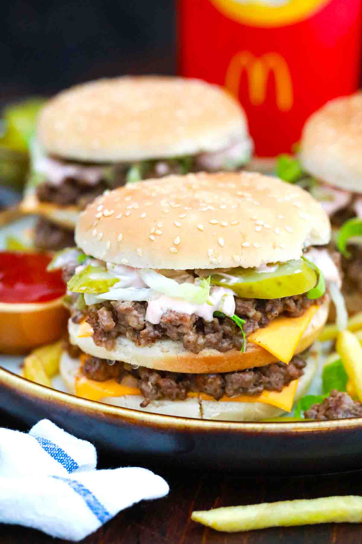 big mac sloppy joes on a plate with fried in the background