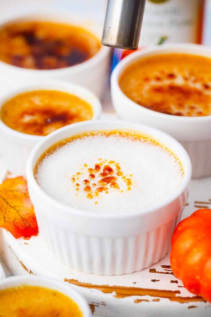 topping pumpkin pie creme brulee with sugar and torching it