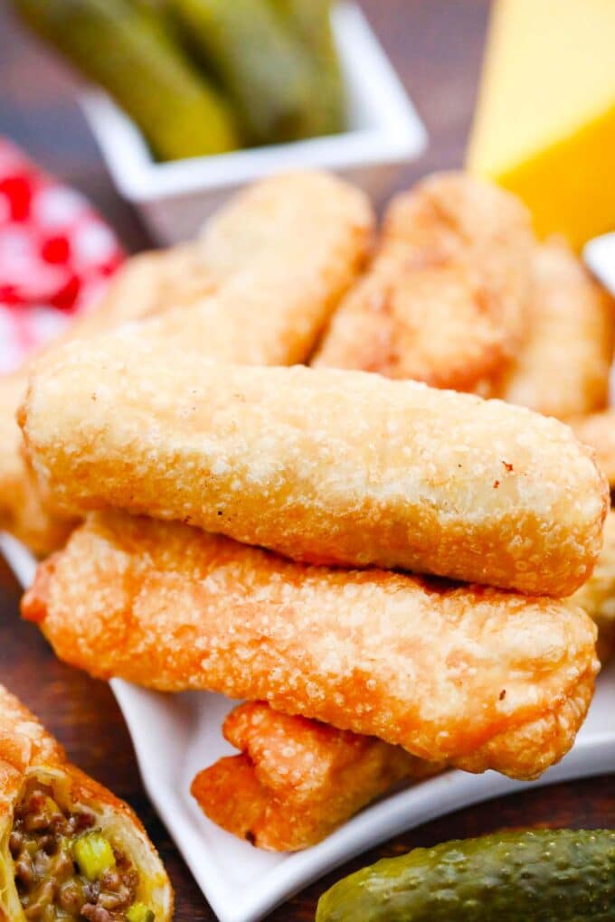 A stack of crispy cheeseburger egg rolls.