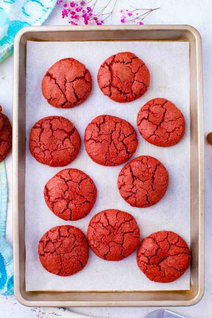 cheesecake stuffed red velvet cookies on a cookie sheet