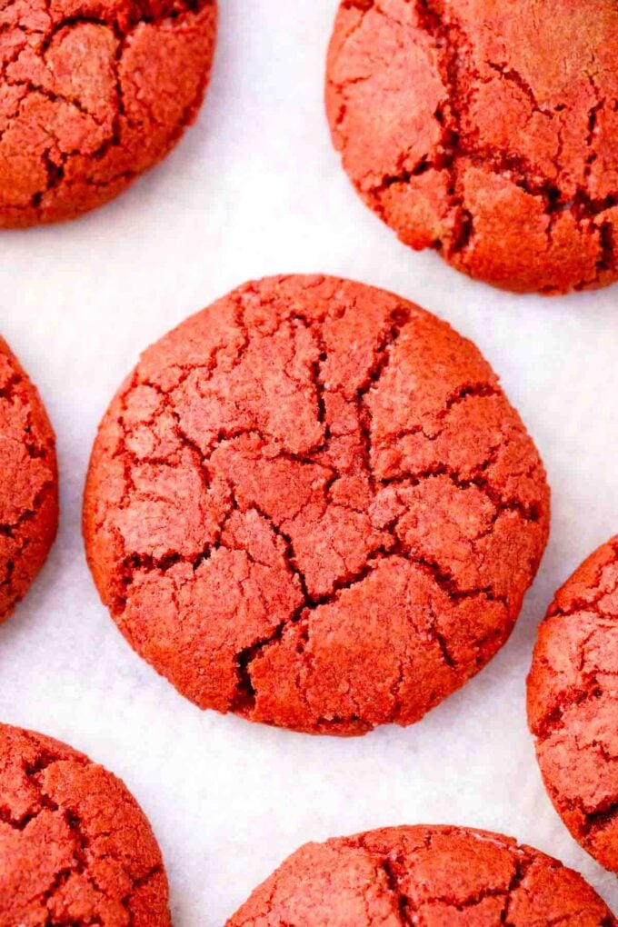 cheesecake stuffed red velvet cookies arranged on a cookie sheet