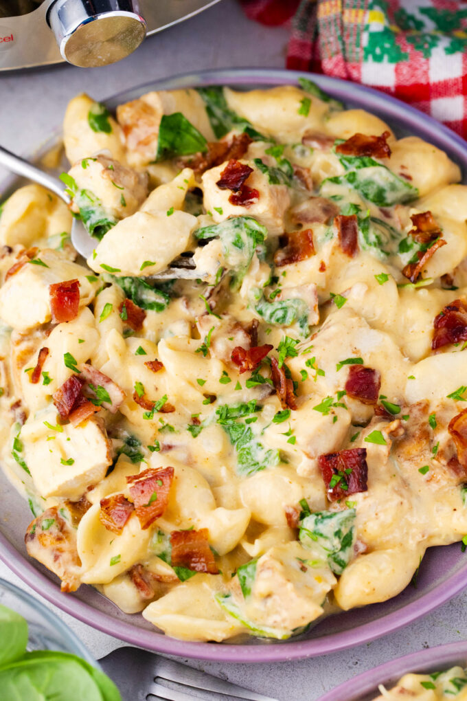 Overhead shot of a serving plate of cheesy instant pot chicken bacon ranch pasta.