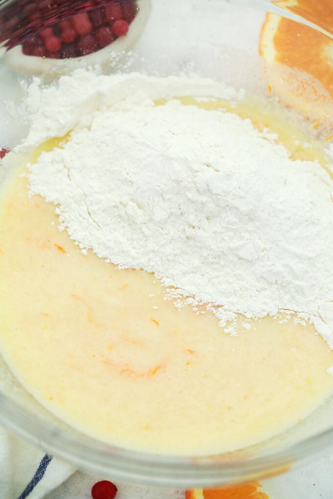 Mixing dry ingredients into wet ingredients.