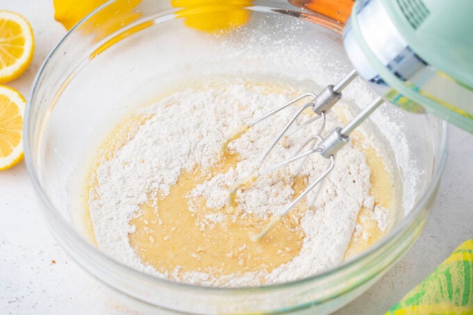Combining wet and dry ingredients for carrot zucchini bread.