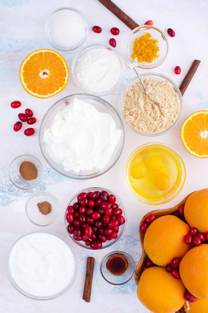 cranberry cheesecake ingredients arranged in bowls on a table