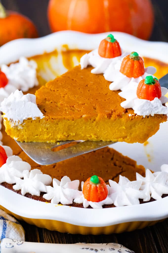 A slice of creamy crustless pumpkin pie on a serving spatula.