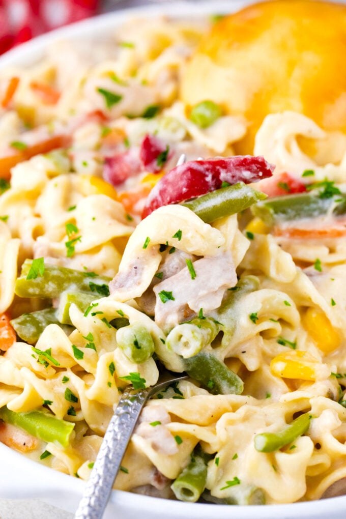 Close shot of a forkful of cheesy instant pot chicken pot pie pasta.