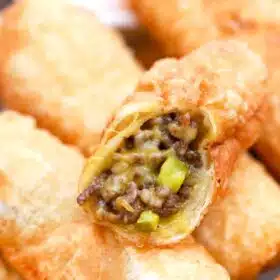 a plate of cheesy cheeseburger egg rolls