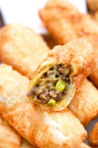 a plate of cheesy cheeseburger egg rolls