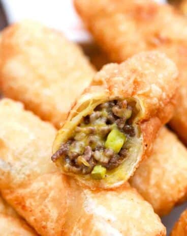 a plate of cheesy cheeseburger egg rolls