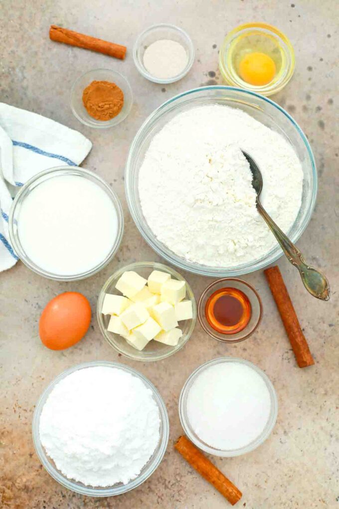 overhead shot of flour sugar butter vanilla eggs cream cheese on a table