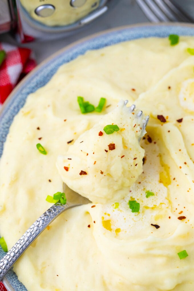A forkful of homemade slow cooker mashed potatoes.
