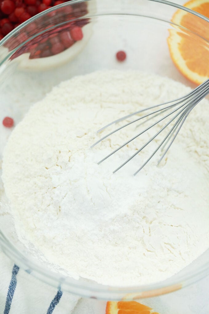 Stirring dry ingredients for cranberry orange bread.