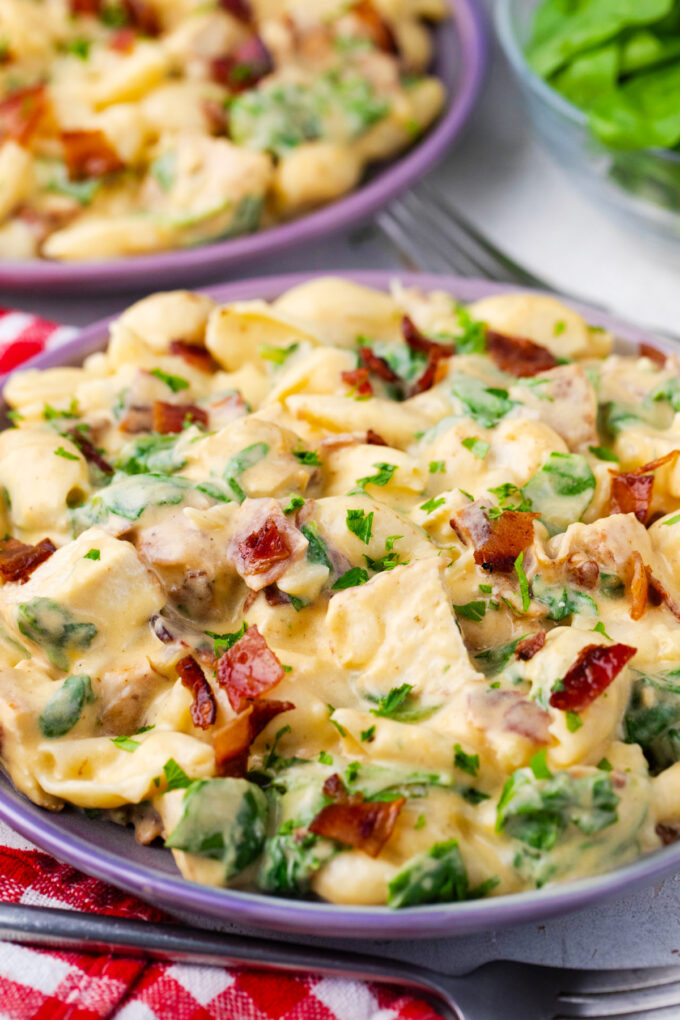Cheesy instant pot chicken bacon ranch pasta with spinach.