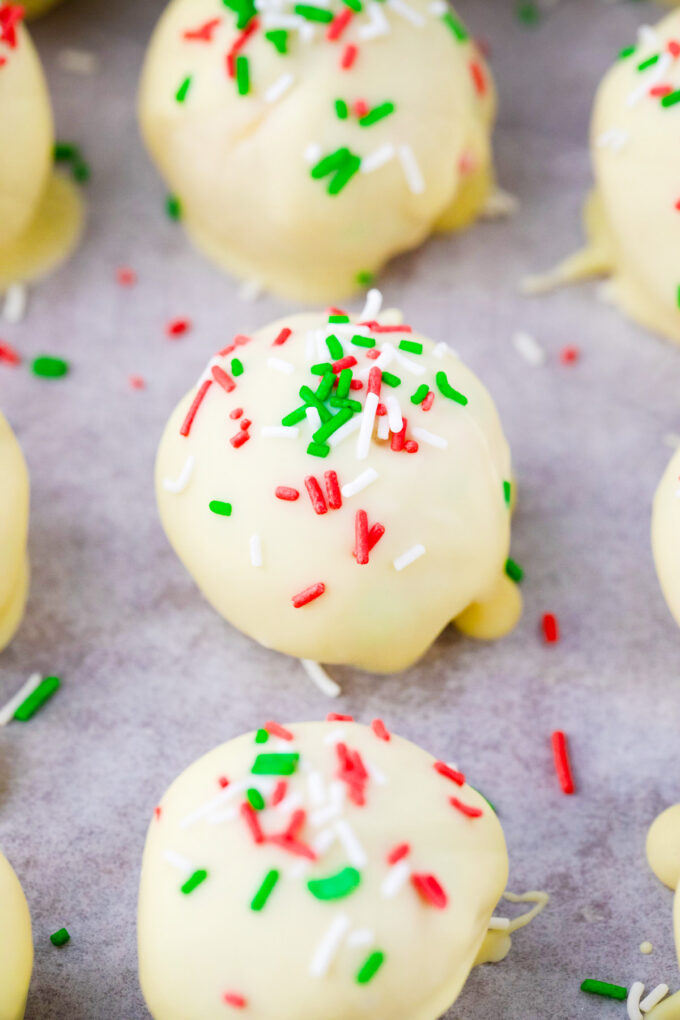 Homemade sugar cookie truffles on a cookie sheet.