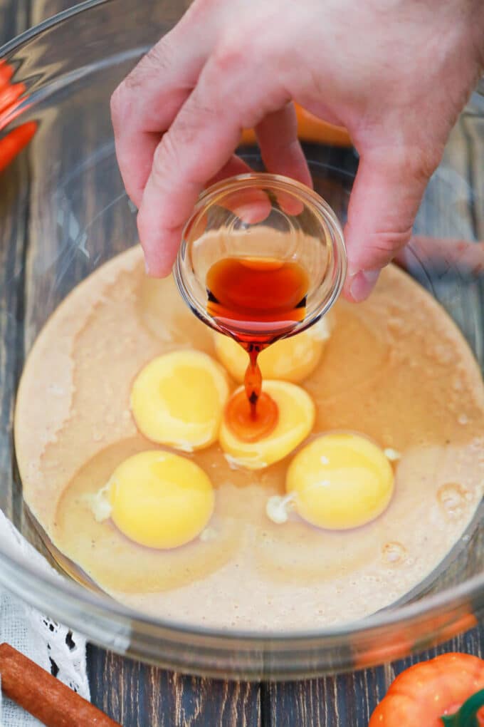 Adding vanilla to creamy crustless pumpkin pie batter.