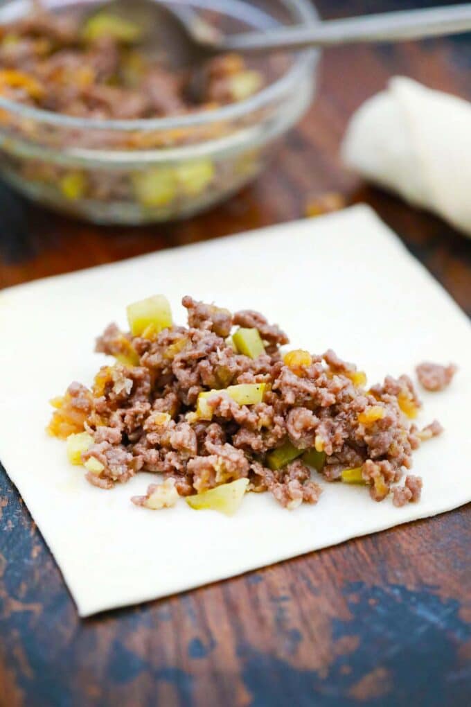 Stuffing a cheeseburger egg roll.