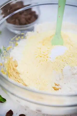 adding flour to butter and sugar mix