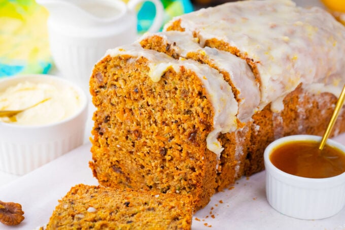 Homemade carrot zucchini bread topped with lemon glaze.