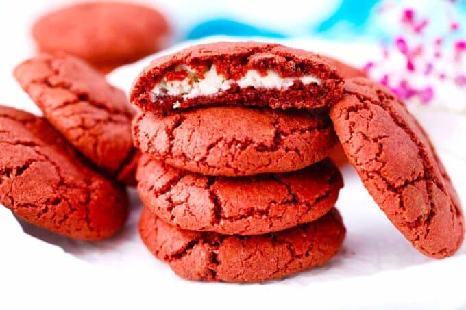 a stack of cheesecake stuffed red velvet cookies