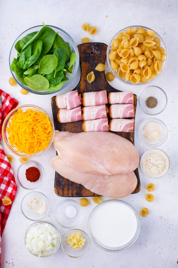 Overhead shot of instant pot chicken bacon ranch pasta ingredients arranged on a white surface.